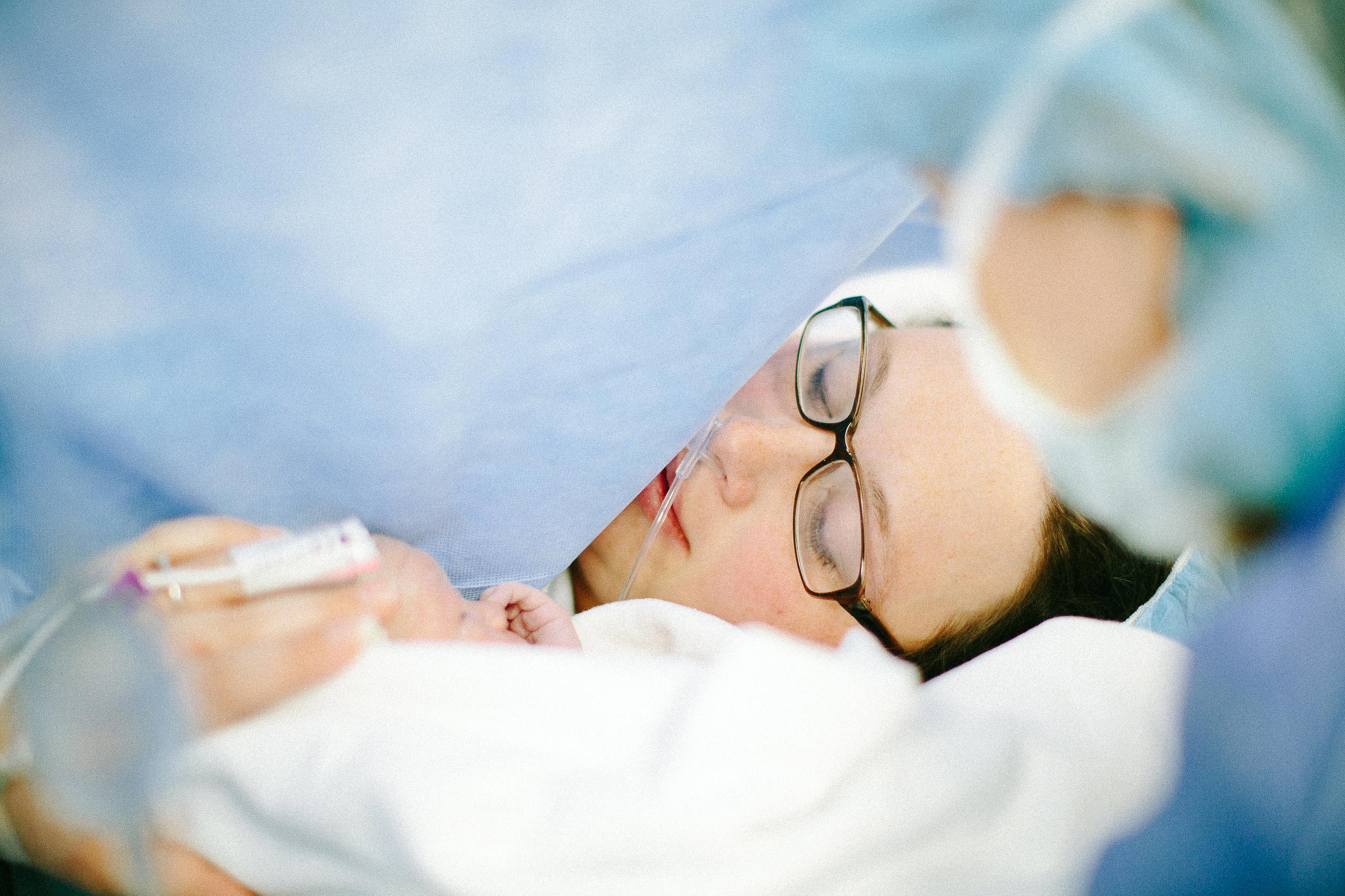 birth story mother in c-section labor and delivery photo in hospital newborn photographer